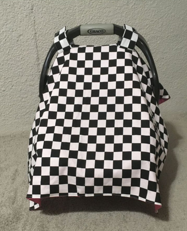 Checkered baby car seat cover with red interior.
Car Seat Canopy Cover: Racing Theme Nursery - The Creative Raccoon