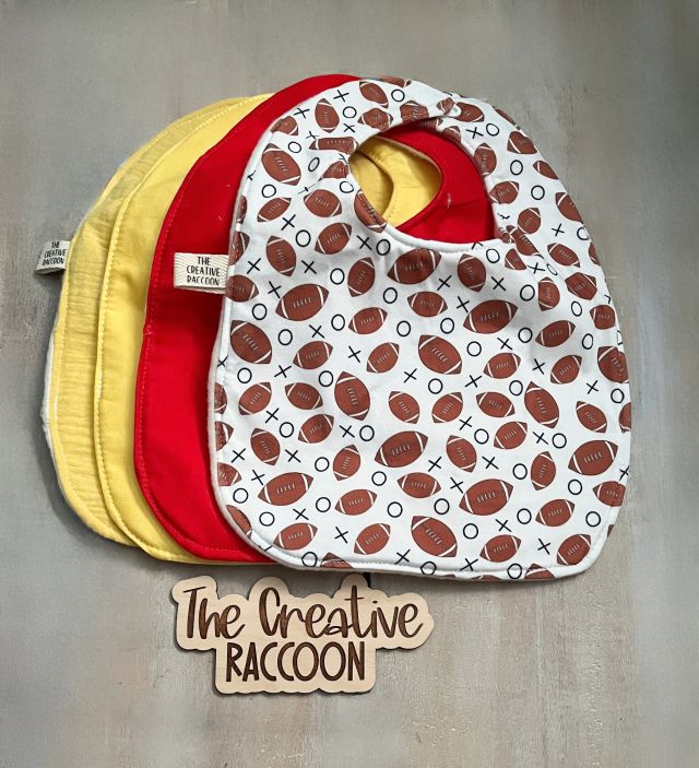 football themed baby bibs shown in solid yellow, solid red & footballs on a white background. Handmade in Kansas, USA
Football Baby Gift Sets, Kansas Theme - The Creative Raccoon