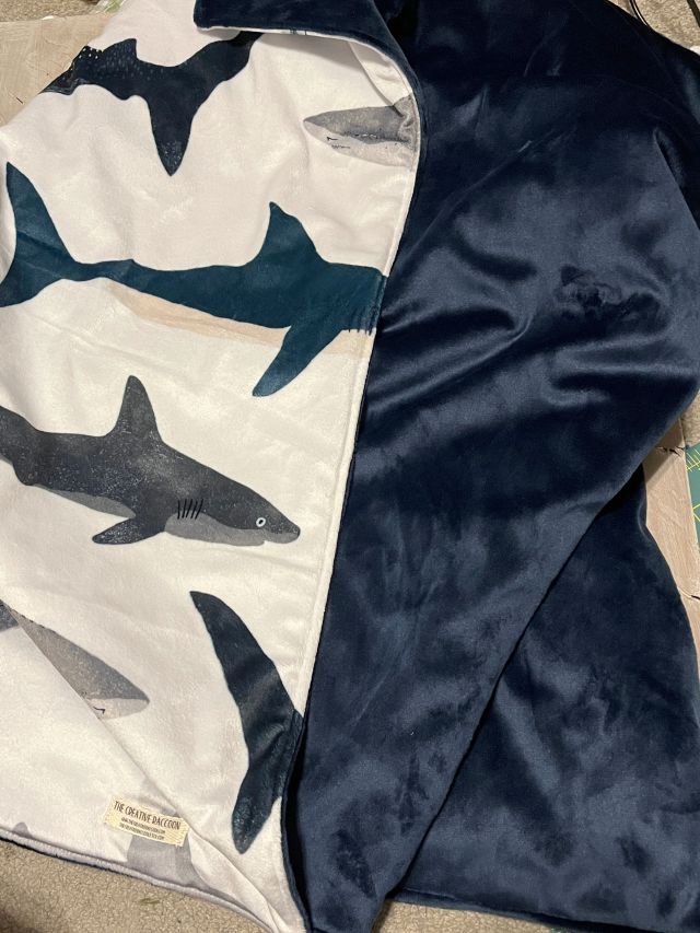 Blanket with shark pattern on one side and solid color on the other
Shark Baby Blanket, Nautical Themed Nursery - The Creative Raccoon