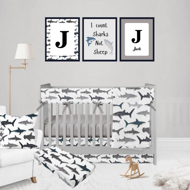 Nursery room with crib, shark-themed bedding, and wall art.
Shark Rail Cover, Nautical Themed Nursery - The Creative Raccoon