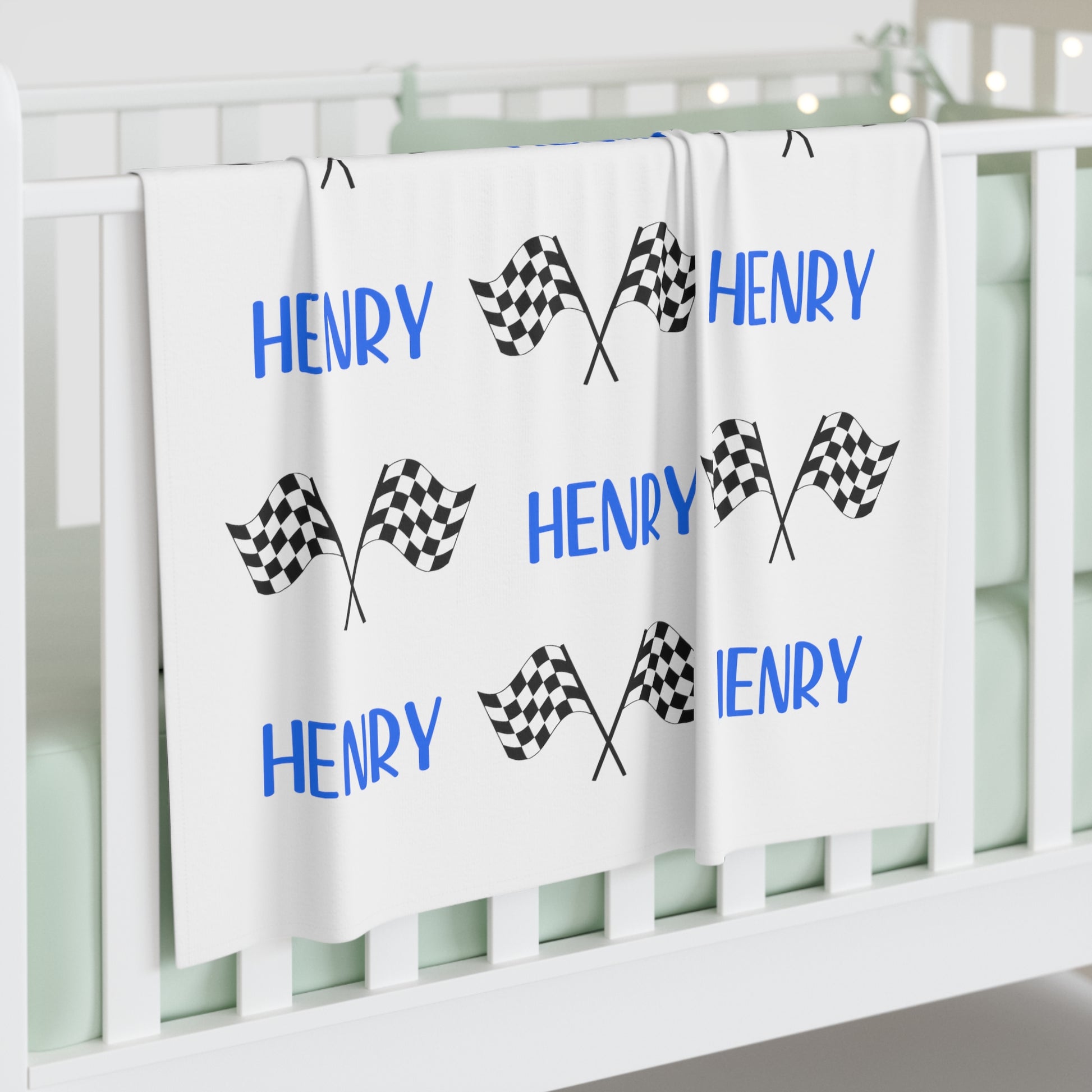racing flag swaddle blanket with name in blue, matching hat upon request.