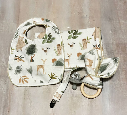 Baby bib, burp cloth, and teething ring with woodland-themed design on a wooden surface.
Baby Gift Set Personalized: Woodland Forest Animals - The Creative Raccoon