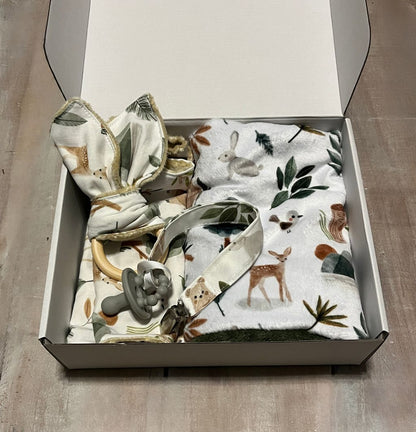 Baby bib, burp cloth, and teething ring with woodland-themed design on a wooden surface.
Baby Gift Set Personalized: Woodland Forest Animals - The Creative Raccoon