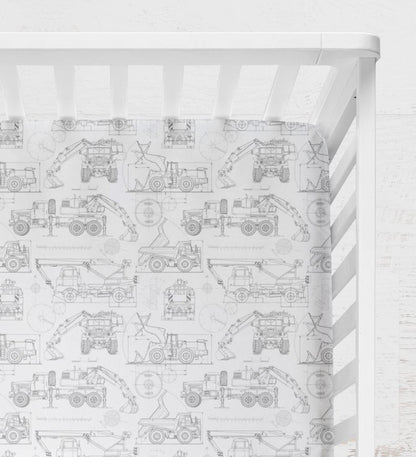 Crib with a white and gray pattern featuring construction vehicles on a white background. Blueprint Construction Trucks Crib Sheet - The Creative Raccoon