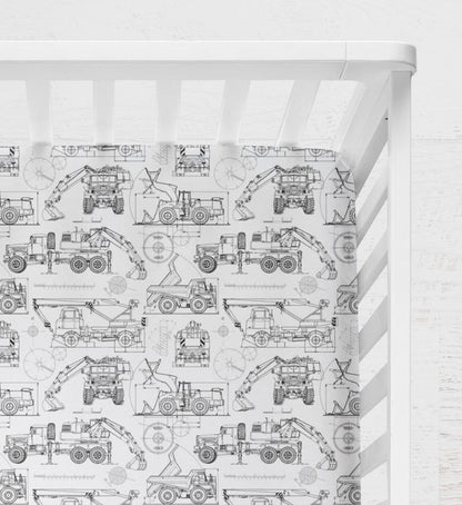 Crib with a white and black pattern featuring construction vehicles on a white background. Blueprint Construction Trucks Crib Sheet - The Creative Raccoon