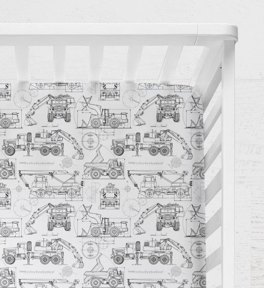 Crib with a white and black pattern featuring construction vehicles on a white background. Blueprint Construction Trucks Crib Sheet - The Creative Raccoon