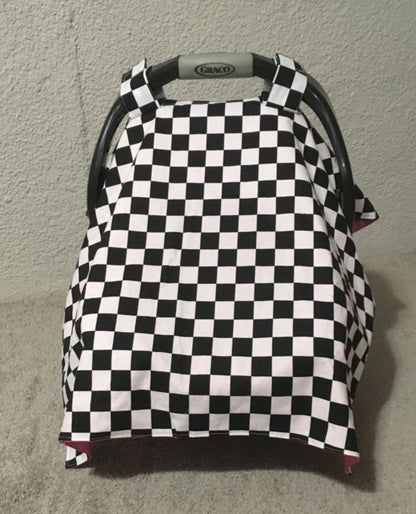 Checkered baby car seat cover with red interior.
Car Seat Canopy Cover: Racing Theme Nursery - The Creative Raccoon