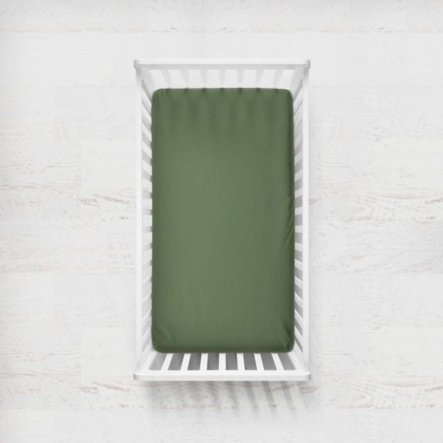 Green fitted sheet on a white crib with a light gray background
Crib Sheet: Dark Sage Gingham - The Creative Raccoon