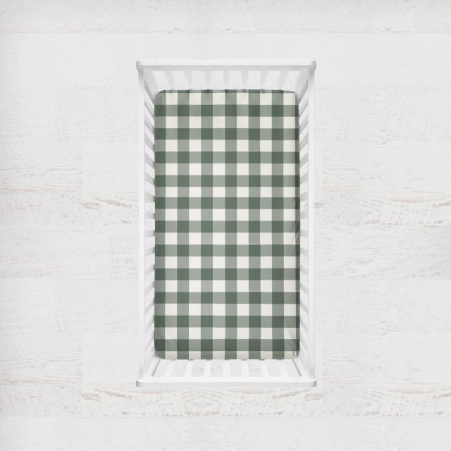 Green and white checkered fabric on a white brick background
Crib Sheet: Forest Green Gingham - The Creative Raccoon