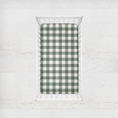 Green and white checkered fabric on a white brick background
Crib Sheet: Forest Green Gingham - The Creative Raccoon