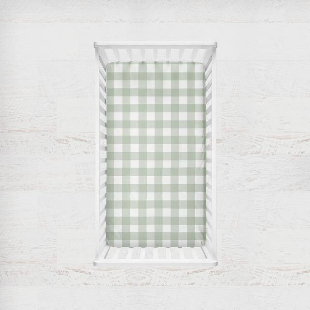 Two crib sheets, one sage gingham plaid and one solid sage. Crib Sheet: Light Sage Gingham - The Creative Raccoon 