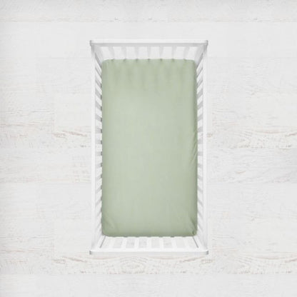 Two crib sheets, one sage gingham plaid and one solid sage. Crib Sheet: Light Sage Gingham - The Creative Raccoon 