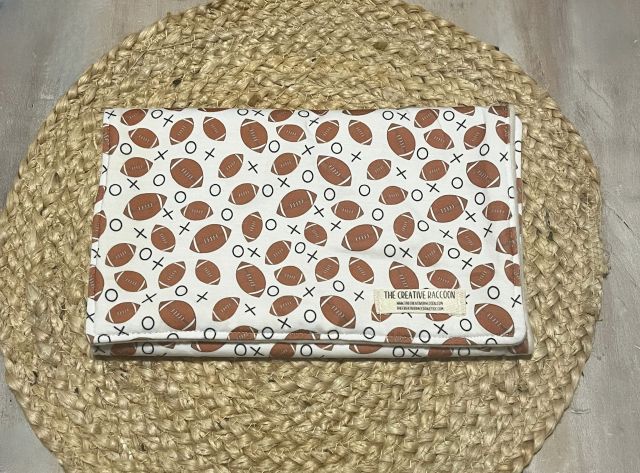Baby burp cloth with football pattern on a woven mat. football themed baby burp cloth shown in footballs on a white background. Handmade in Kansas, USA
Football Baby Gift Sets, Kansas Theme - The Creative Raccoon 