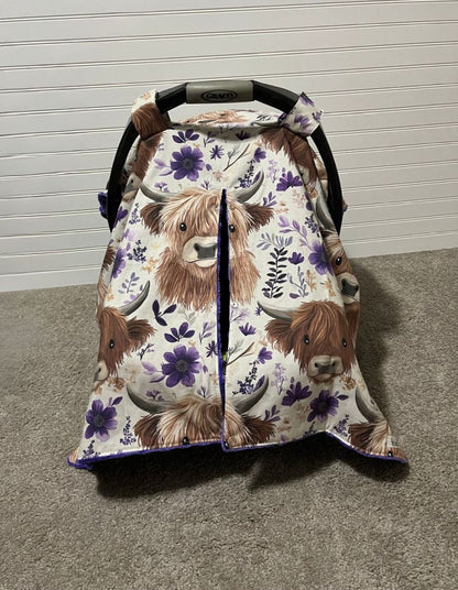 Car seat cover with Highland cow design on a neutral background.
Highland Cow Car Seat Canopy: Farm Floral Nursery Decor - The Creative Raccoon