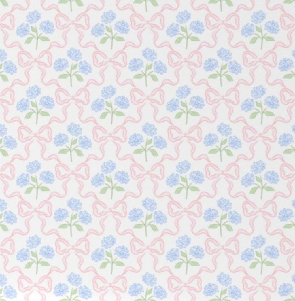 Floral-patterned crib sheet with pink and blue Hydrangeas and Bows flowers on a white crib. Hydrangeas and Bows Crib Sheet - The Creative Raccoon