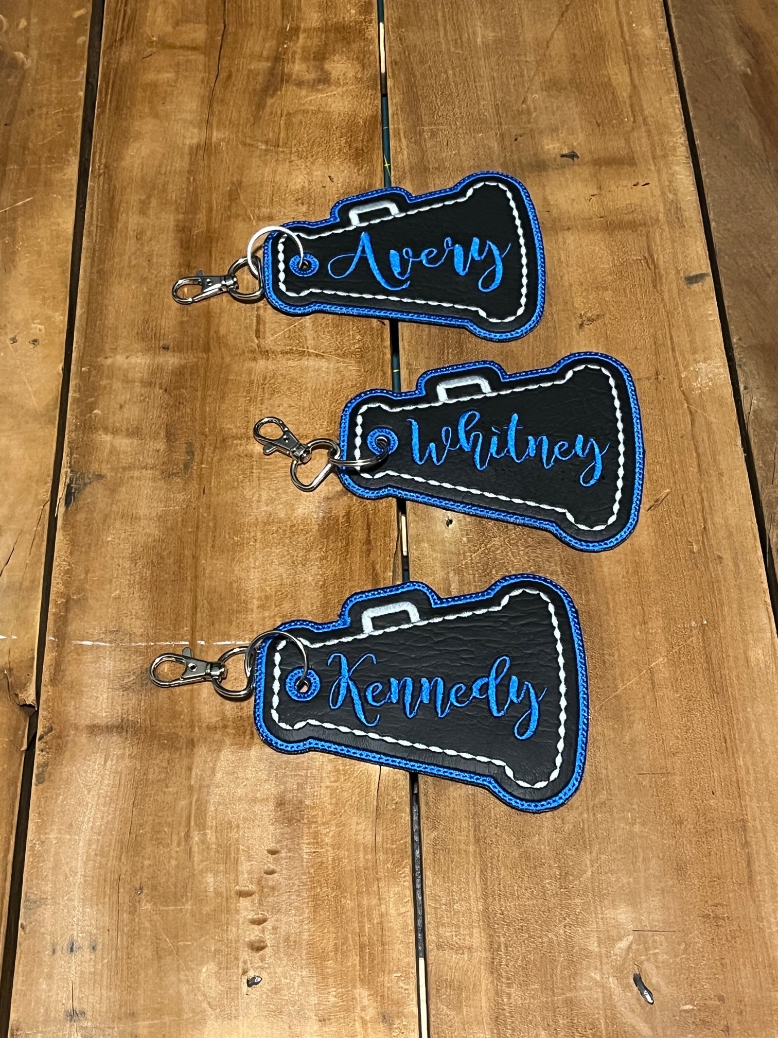 megaphone cheer bag tags shown in black, silver, and blue. Can be personalized with your choice of colors, and name
