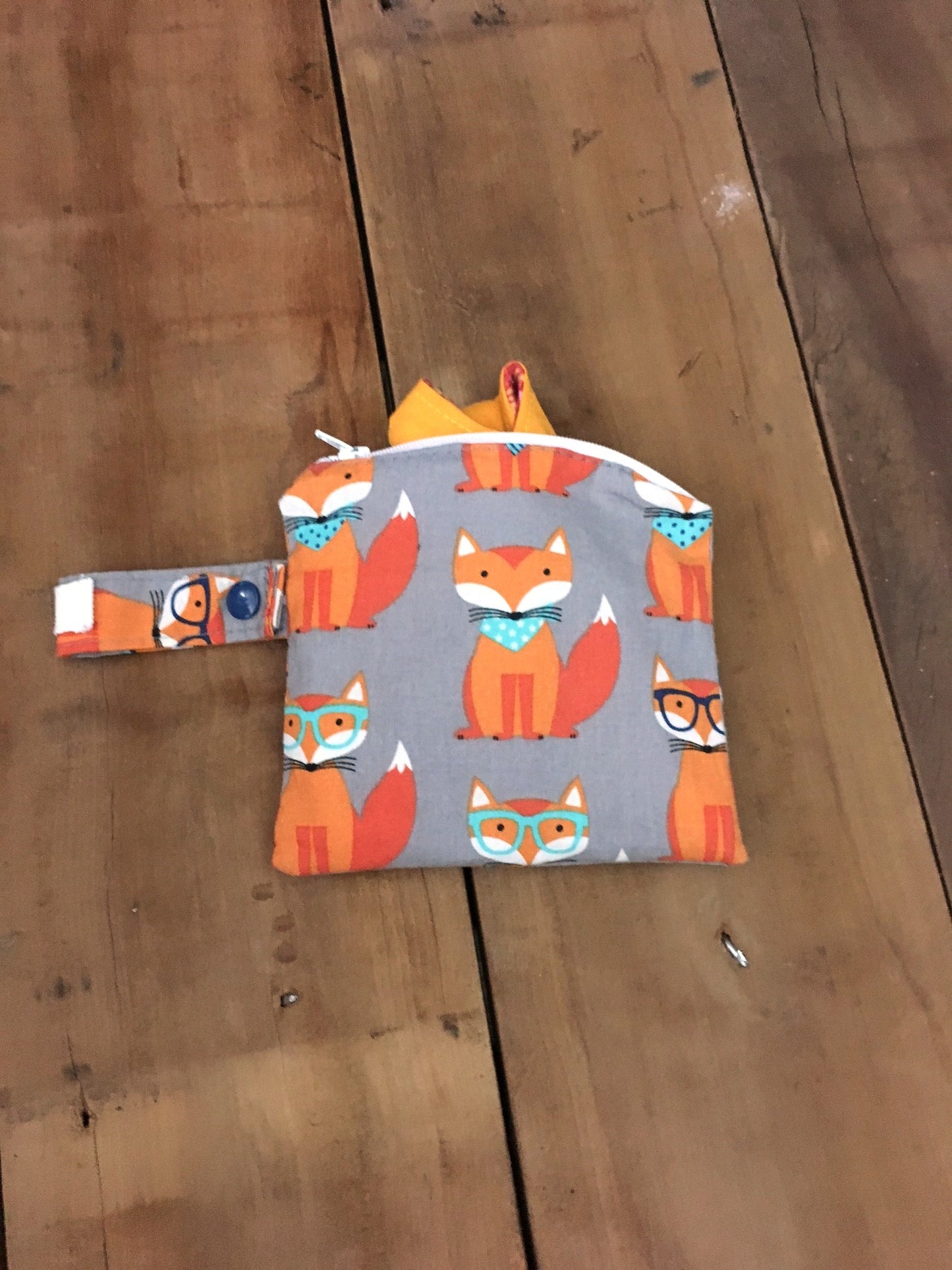 orange fox mini wet bag shown with a cloth pad, cloth pads not included.