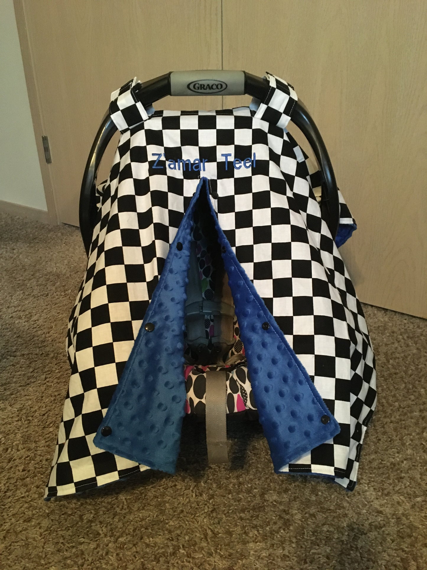 racing check car seat canopy with blue minky back  and opening, also shown with embroidered name add on