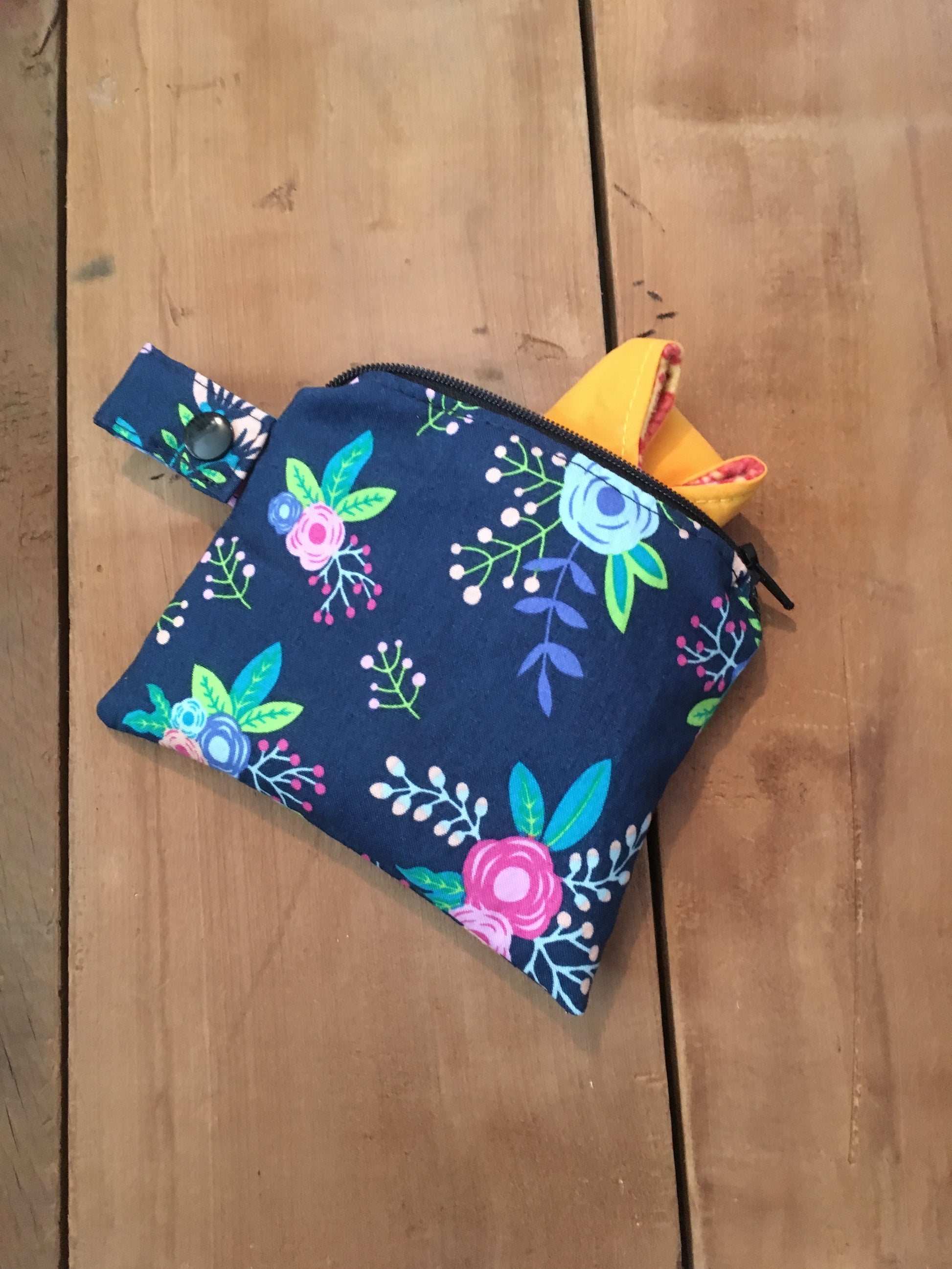 navy floral wet bag shown with strap