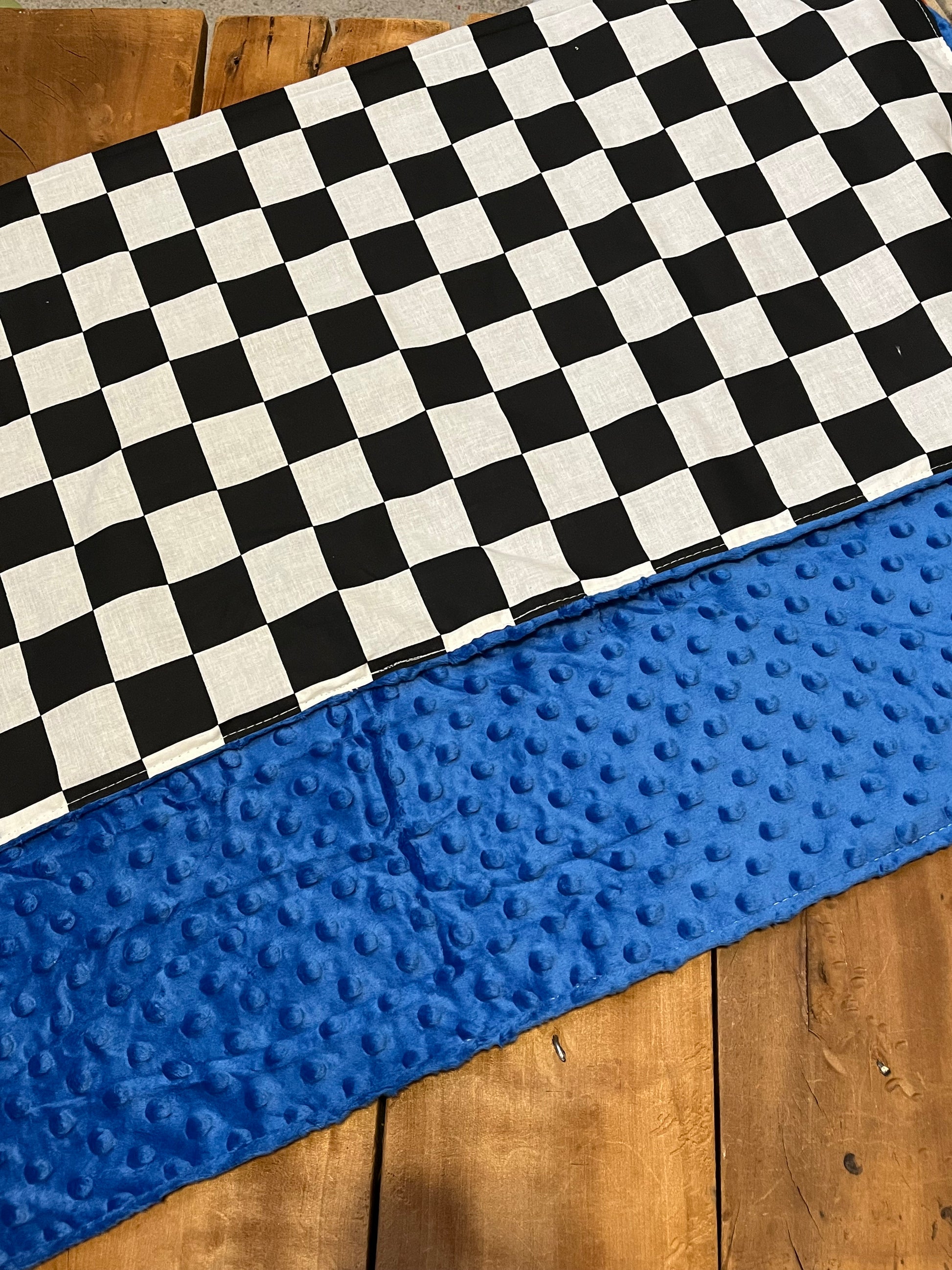 checkered baby blanket shown with blue minky back