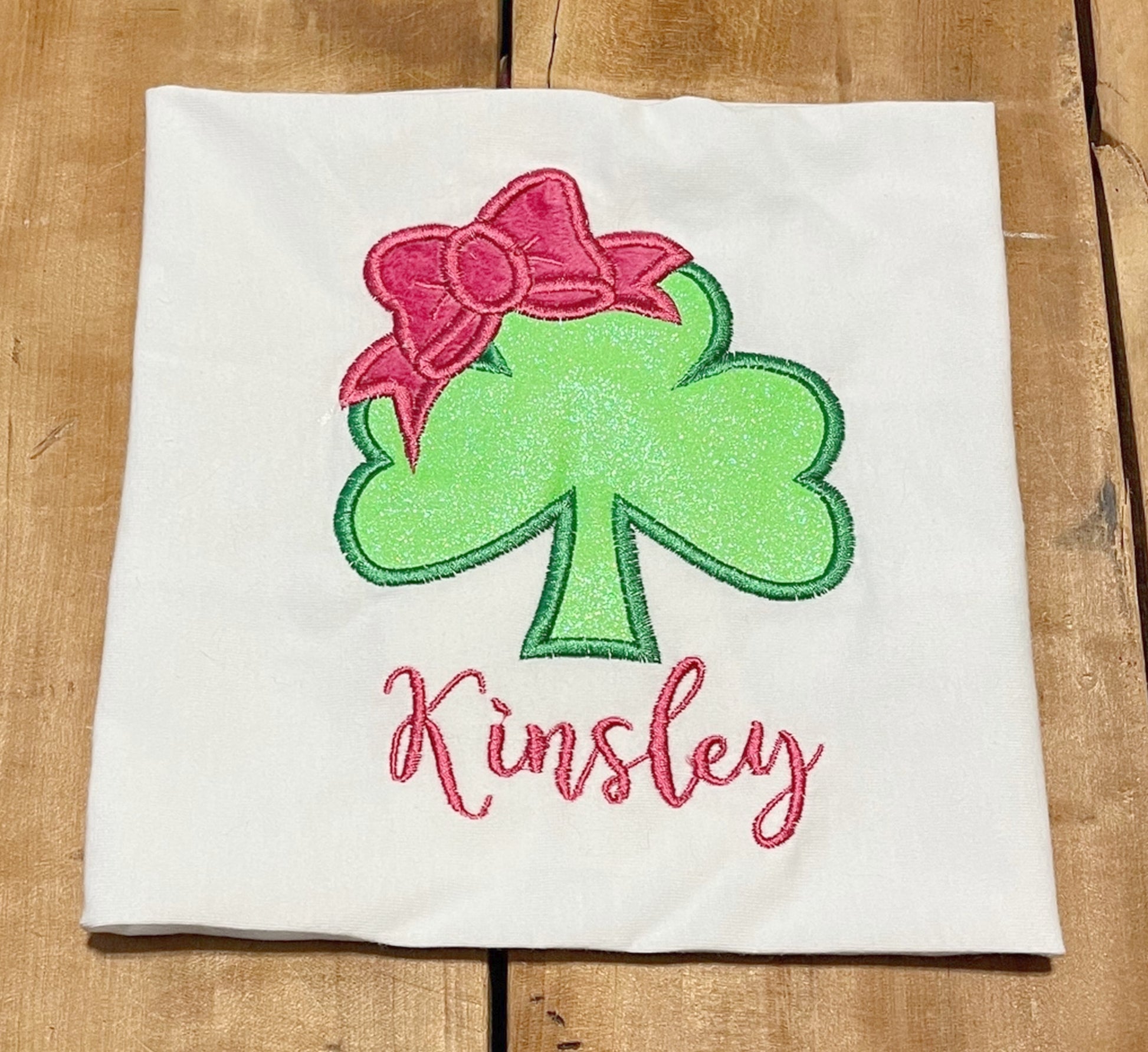 shamrock shirt with bow and optional name, name shown in Everleigh font