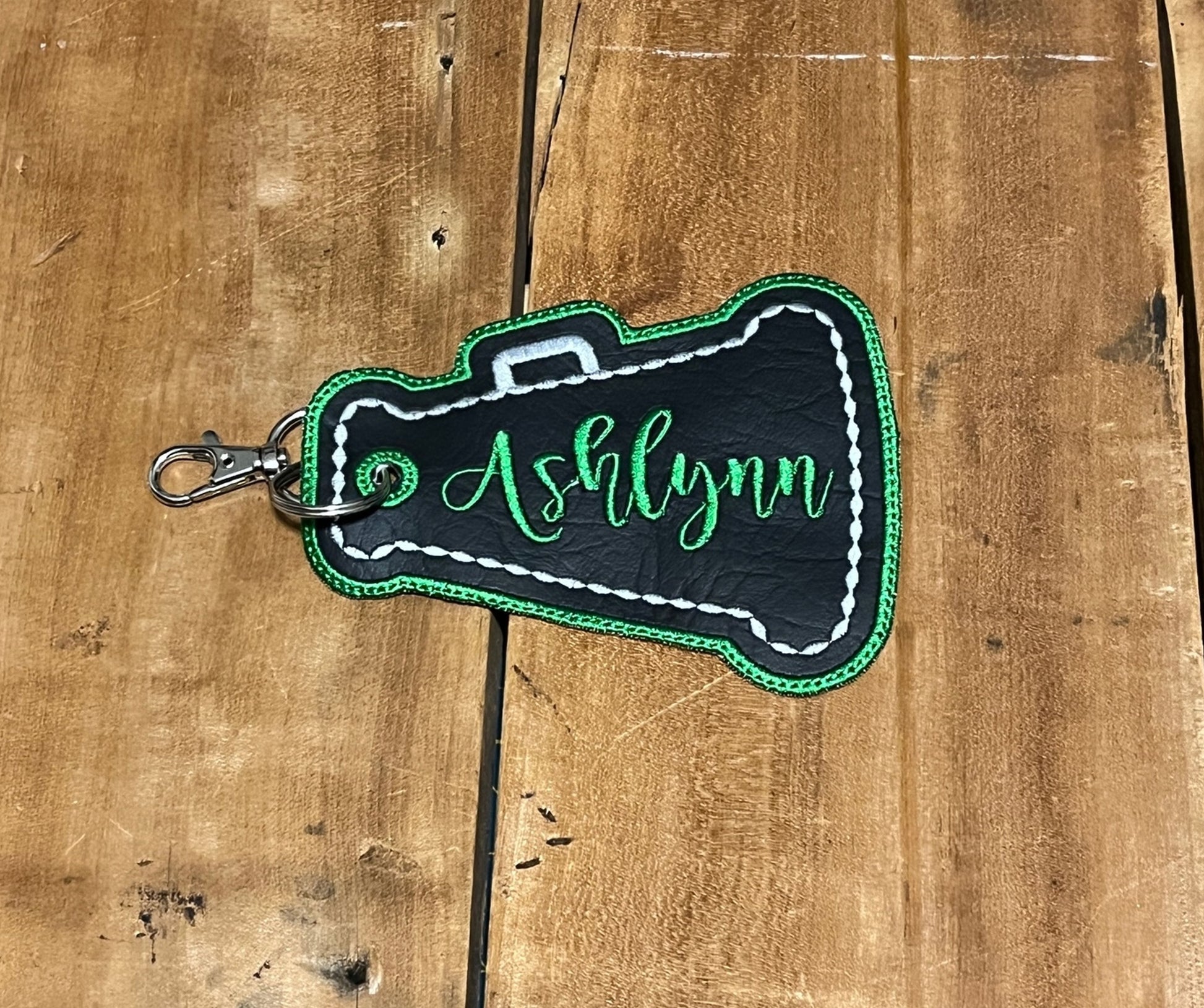 megaphone cheer bag tag shown in black, silver, and green. Can be personalized with your choice of colors, and name