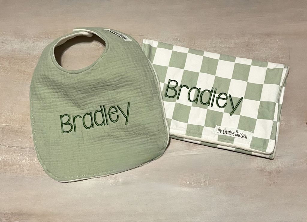 Green bib and checkered burp cloth with 'Bradley' embroidered on both. Sage Green Checkered Bib and Burp Cloth Set - the Creative Raccoon