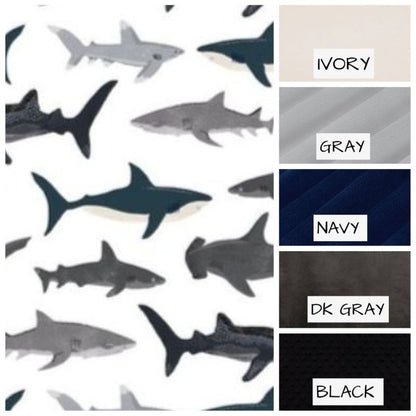 Pattern of sharks with color swatches labeled 'Ivory', 'Gray', 'Navy', 'DK Gray', and 'Black'.
Shark Baby Blanket, Nautical Themed Nursery - The Creative Raccoon