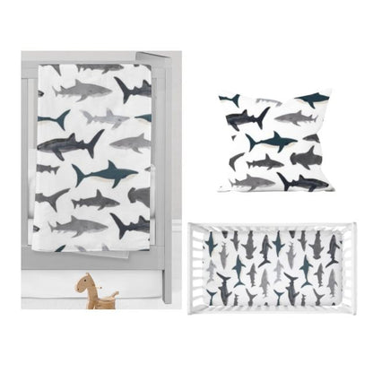 Baby crib with shark patterned bedding on a white background. Shark Nursery Starter Crib Bedding Set - The Creative Raccoon