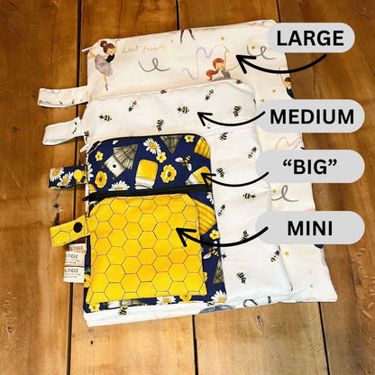 Collection of fabric bags labeled with size categories on a wooden surface.
Wet Dry Bag, Wet Bag, Period Pouch - The Creative Raccoon