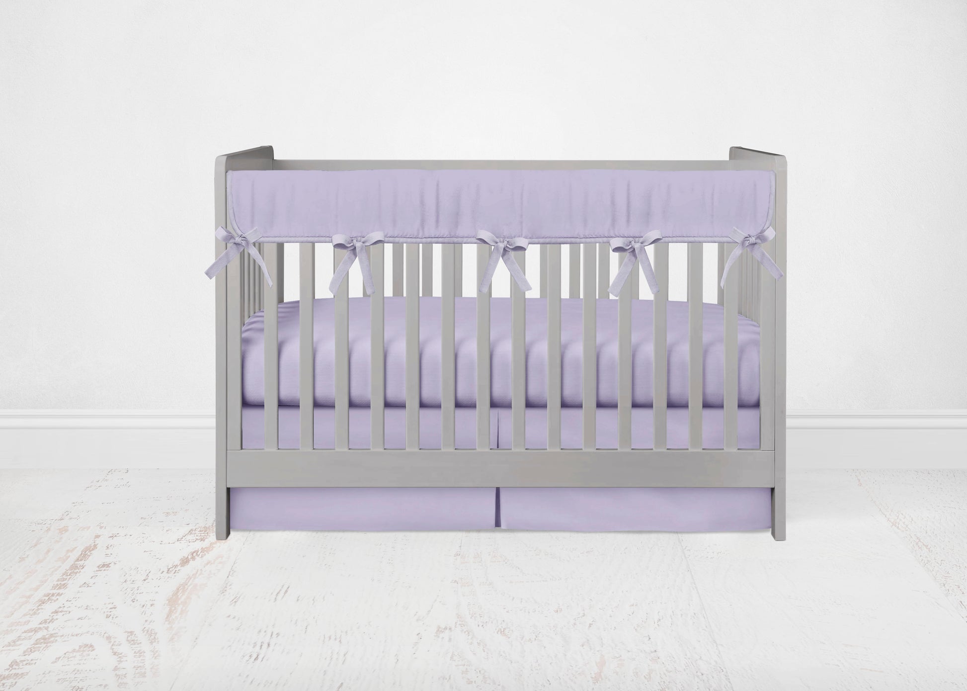  mini crib rail cover, crib sheet and crib skirt shown in the pleat option