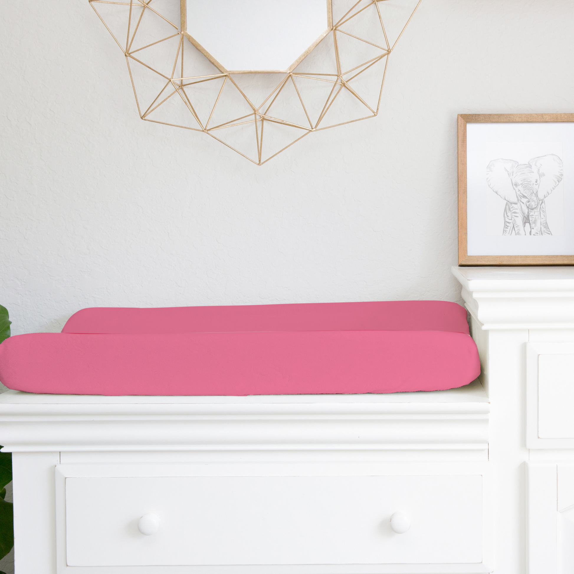 solid hot pink changing pad cover shown on a changing pad