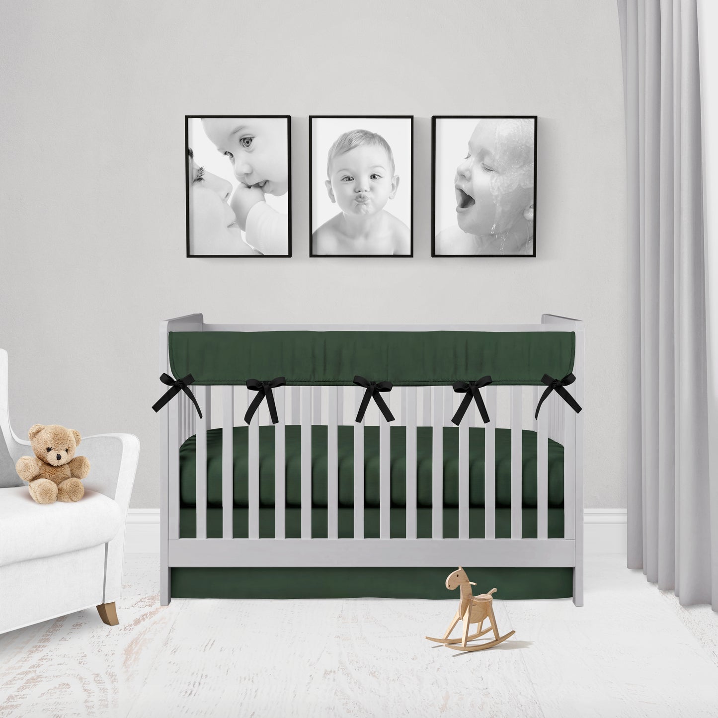 dark hunter green mini crib rail cover with black ties, crib sheet & crib skirt shown in flat