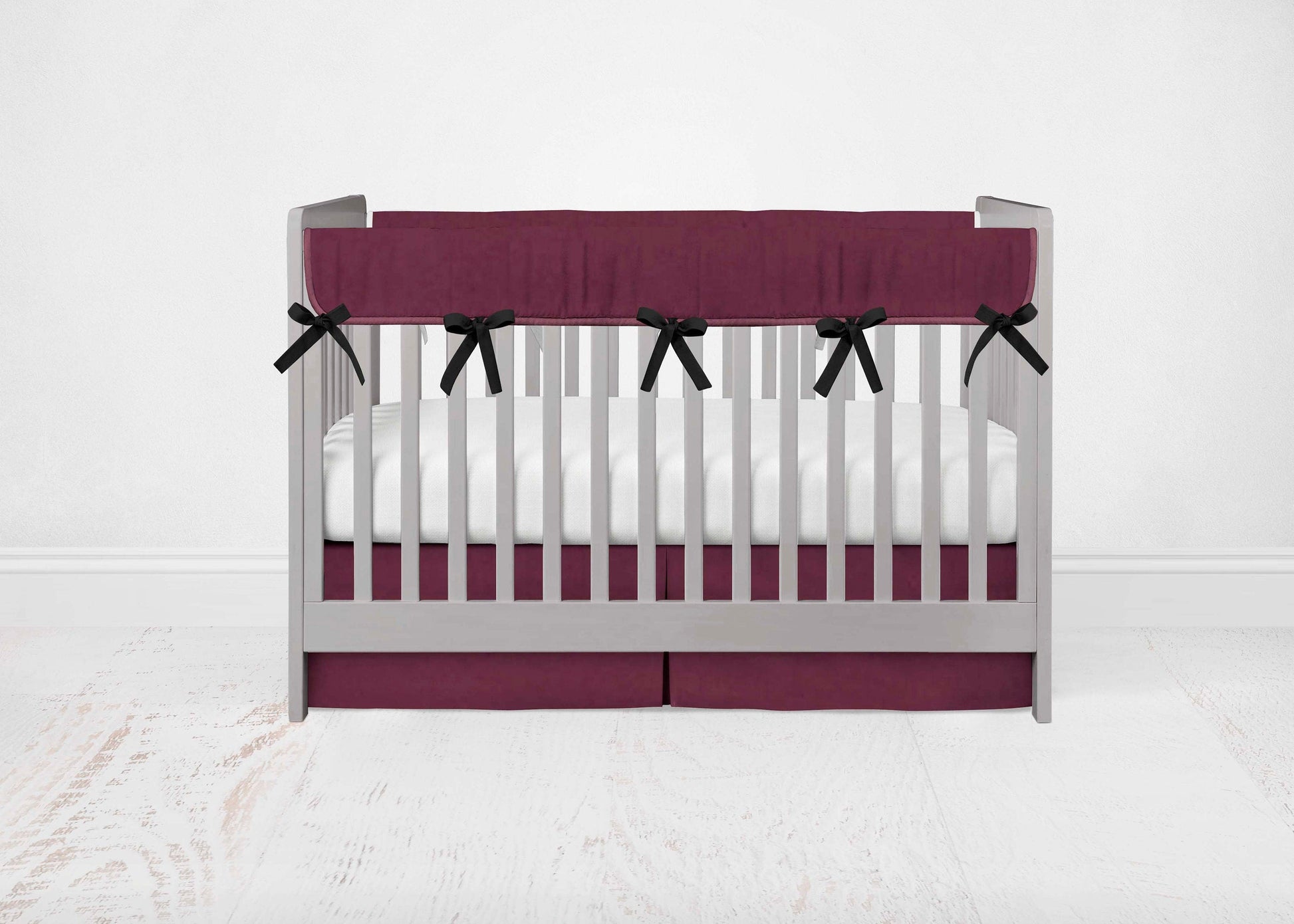maroon rail cover with black ties & maroon crib skirt shown in the pleat option