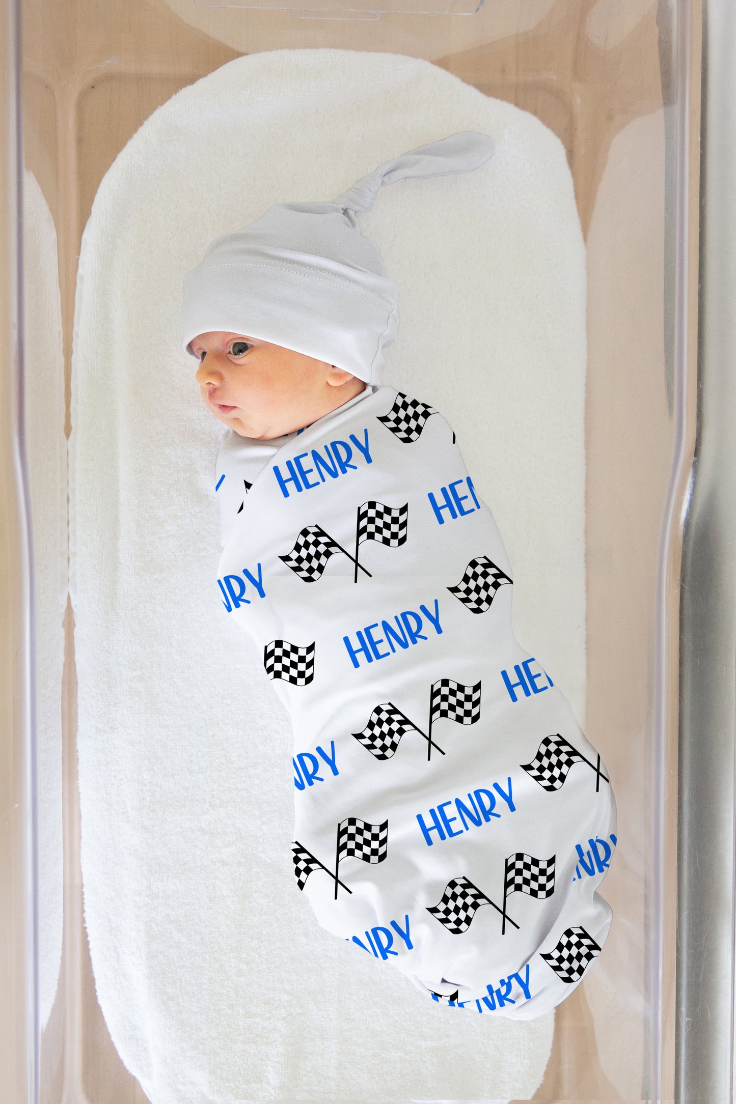 racing flag swaddle blanket with name in blue, matching hat upon request.