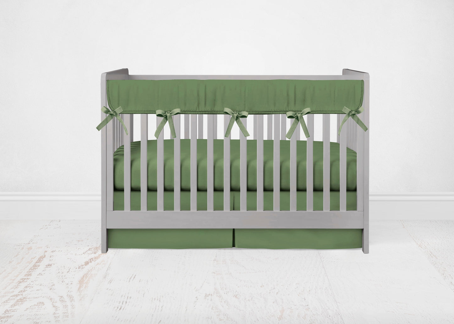 green crib rail cover with pine green ties, crib sheet & crib skirt shown in pleat option