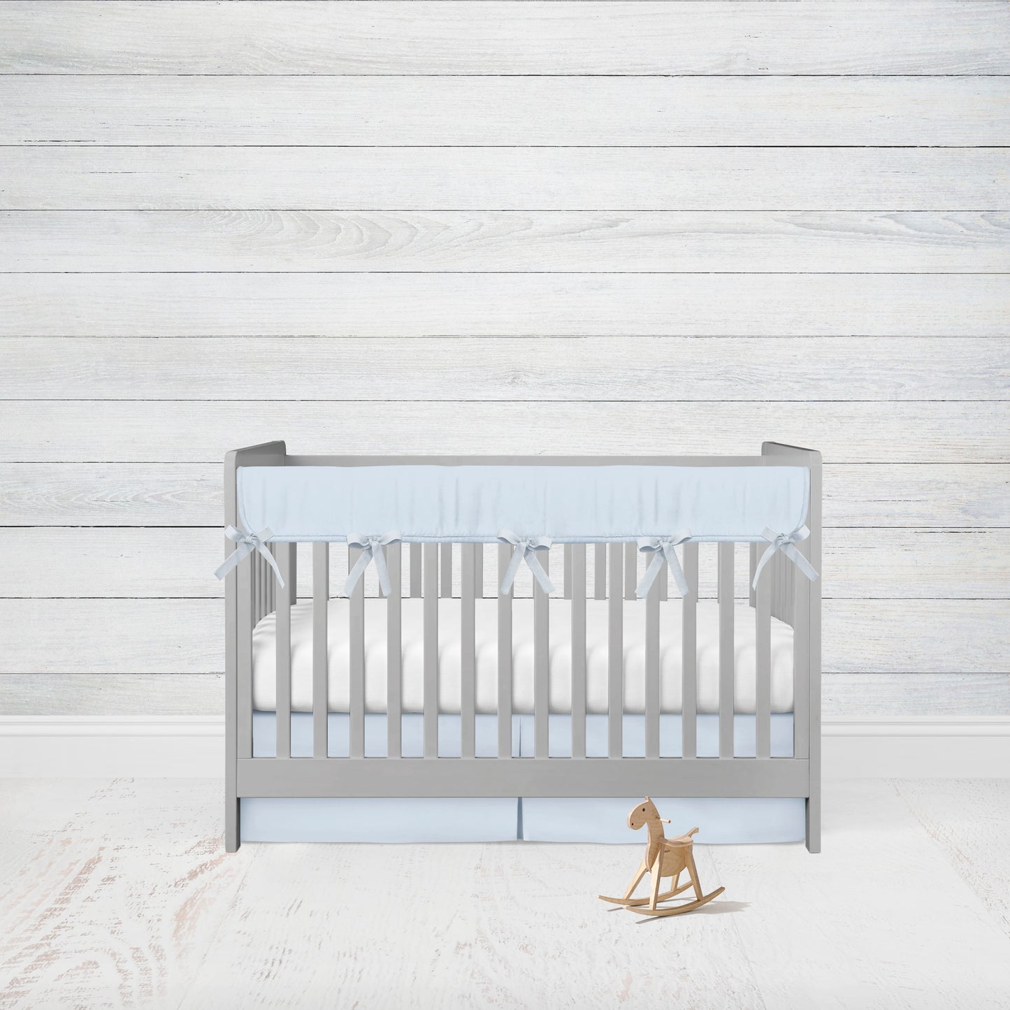 light blue rail cover and crib skirt in the pleated option