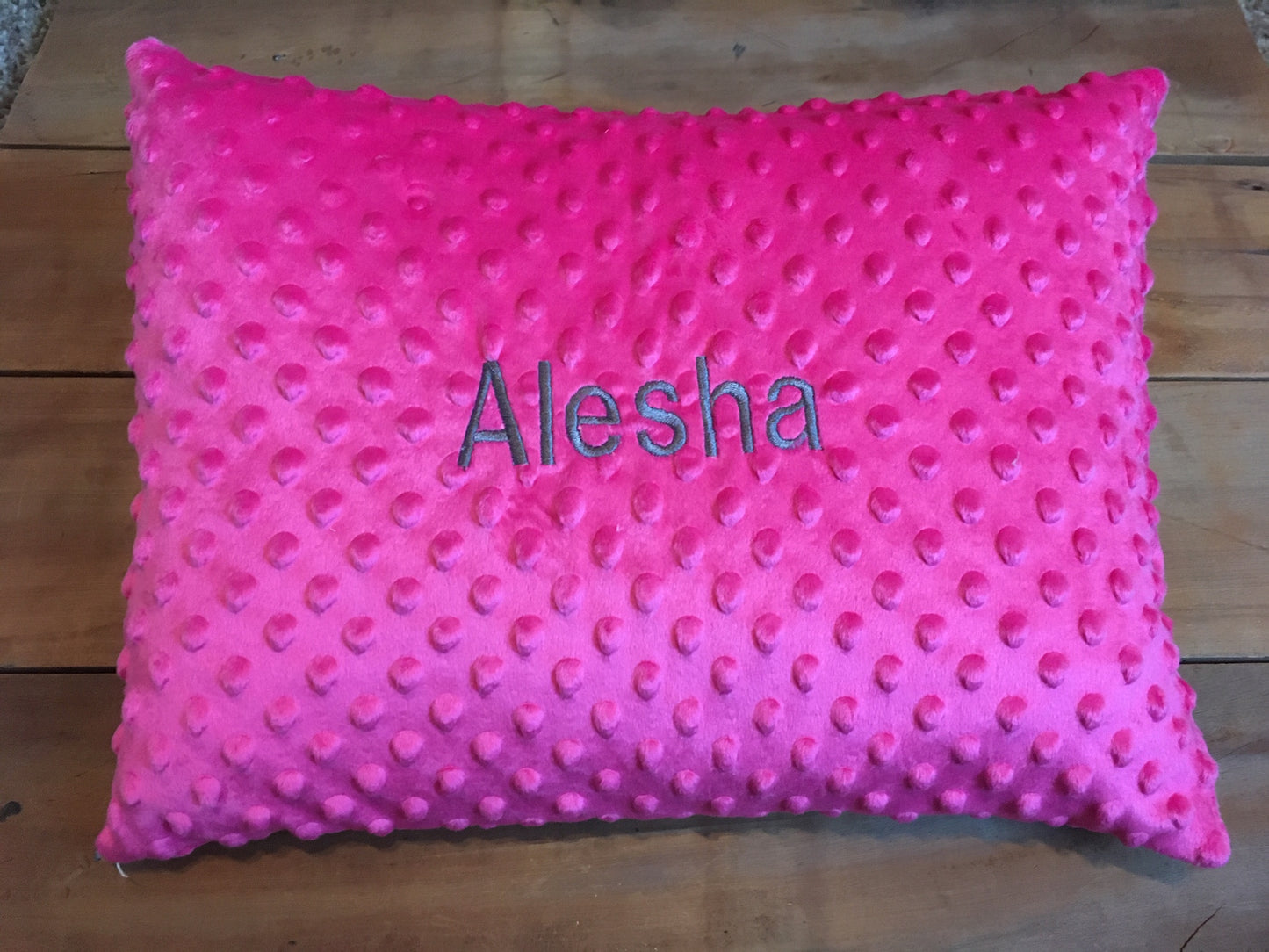 pink minky pillow cover shown with embroidered name in dark gray thread