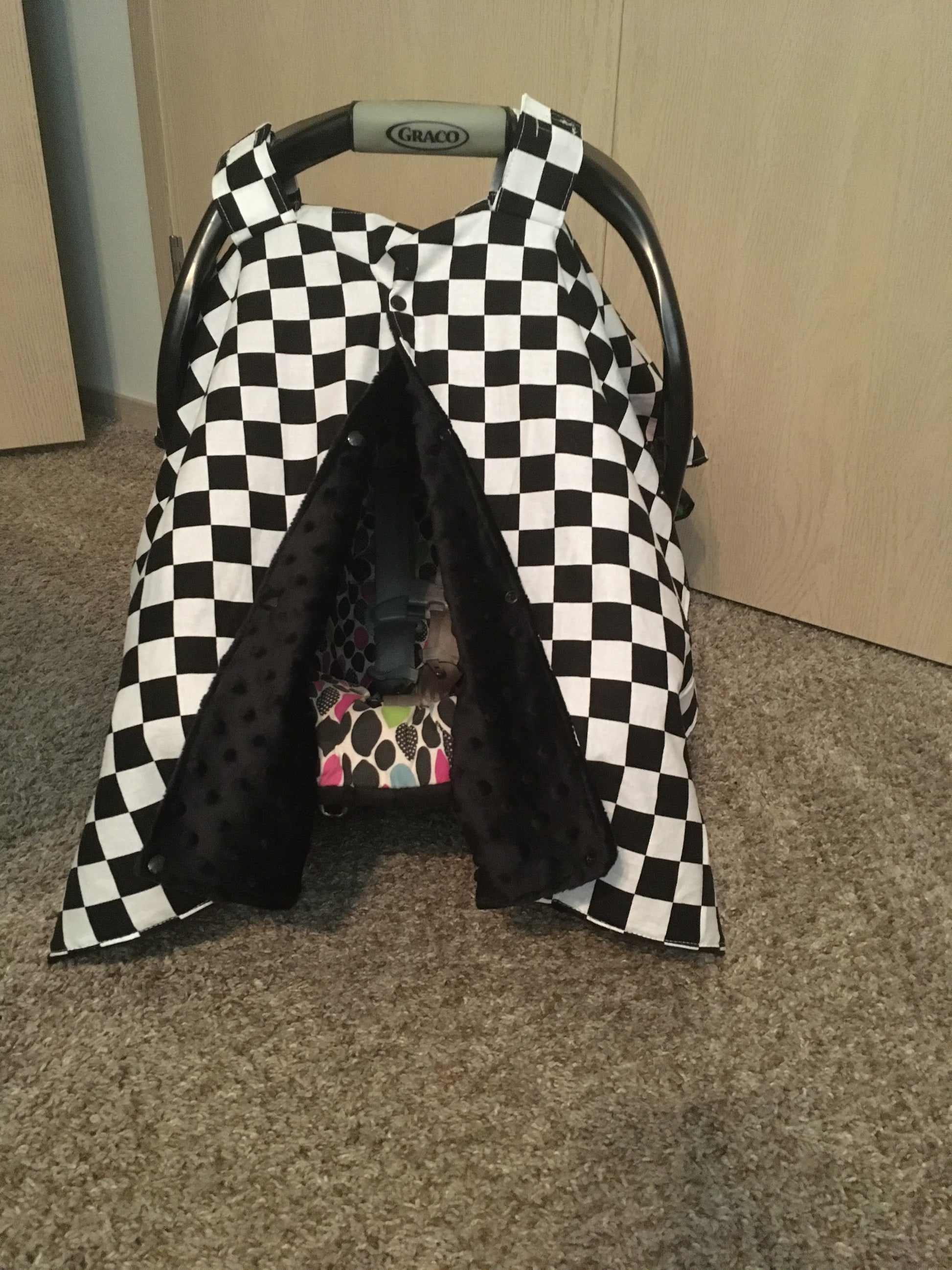 racing check car seat canopy shown in black minky, in the open option