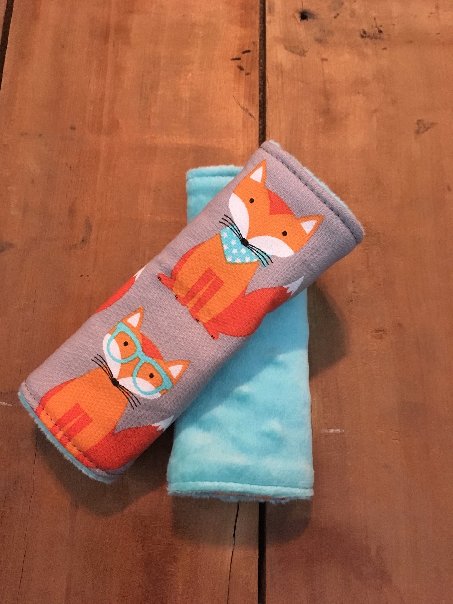 orange nerdy fox car seat strap covers shown in size 5"-6" shown in aqua minky