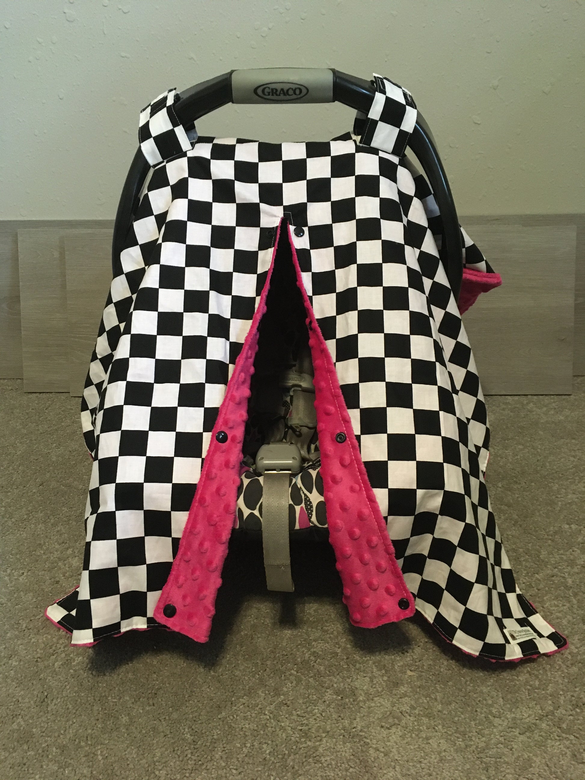 racing check car seat canopy shown in hot pink minky, in the open option