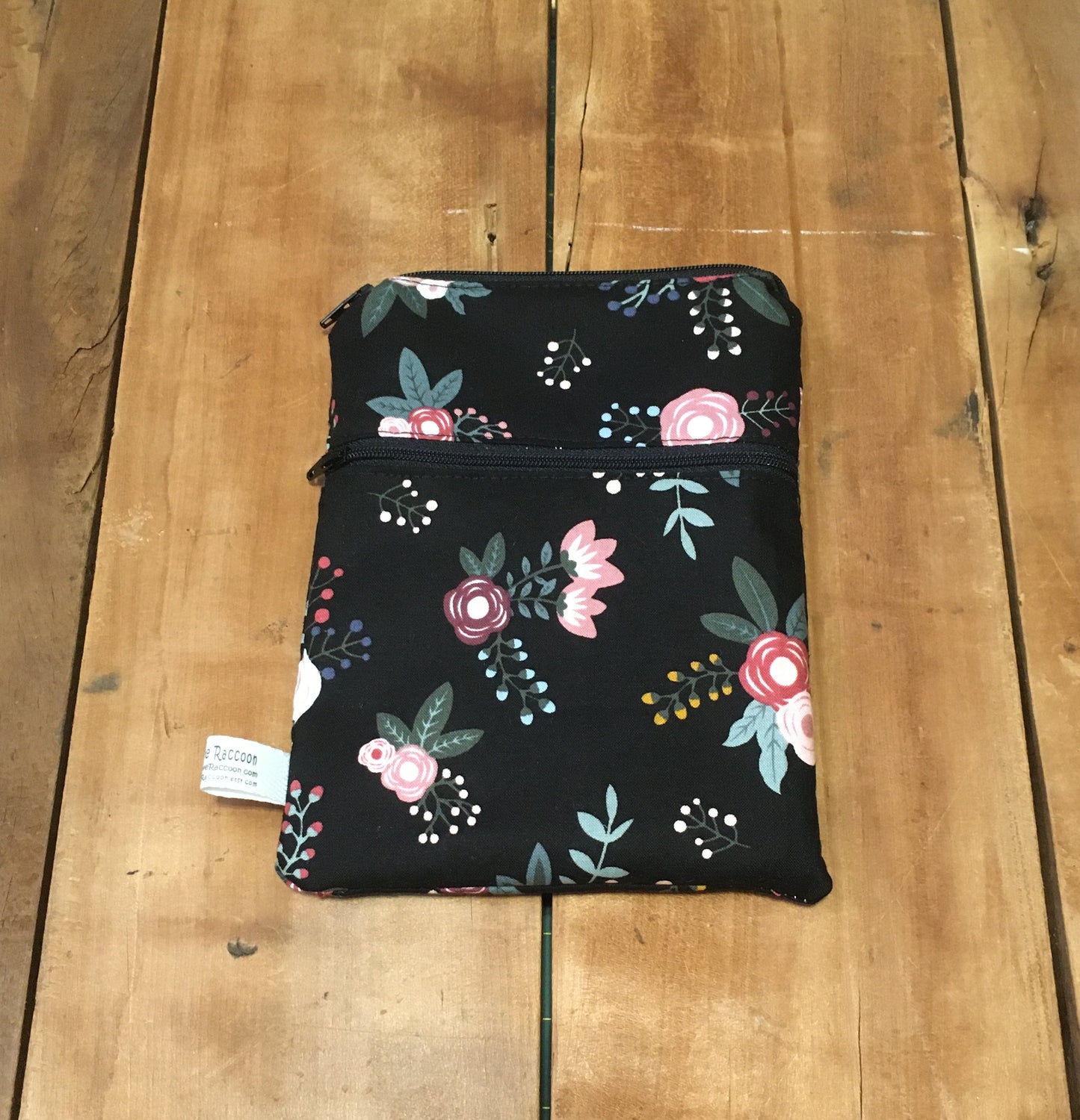black floral wet dry bag with wet top pocket and dry front pocket, shown without strap