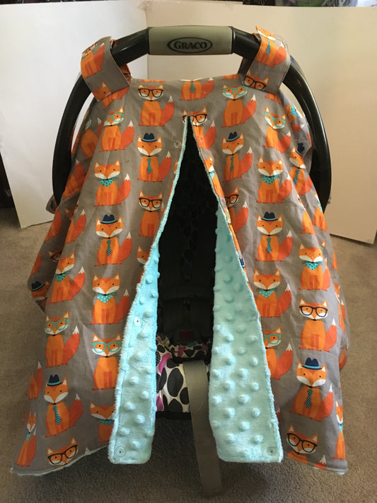 NERDY ORANGE FOX CAR SEAT CANOPY SHOWN WITH AQUA MINKY AND THE OPENING