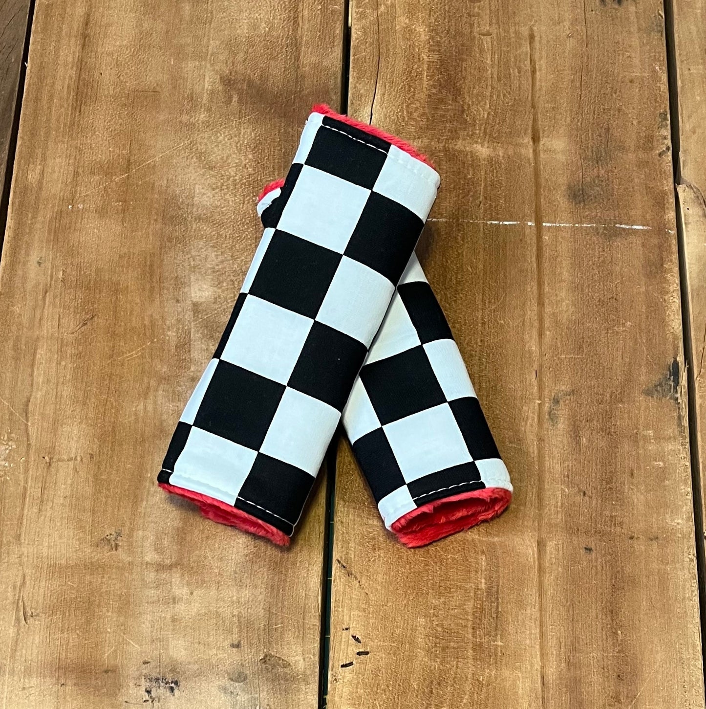racing check car seat strap covers, shown in the 6" size and red minky back