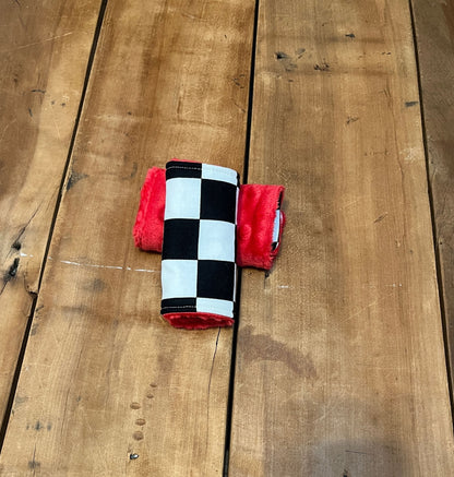 racing check car seat strap covers, shown in the 4" size and red minky back