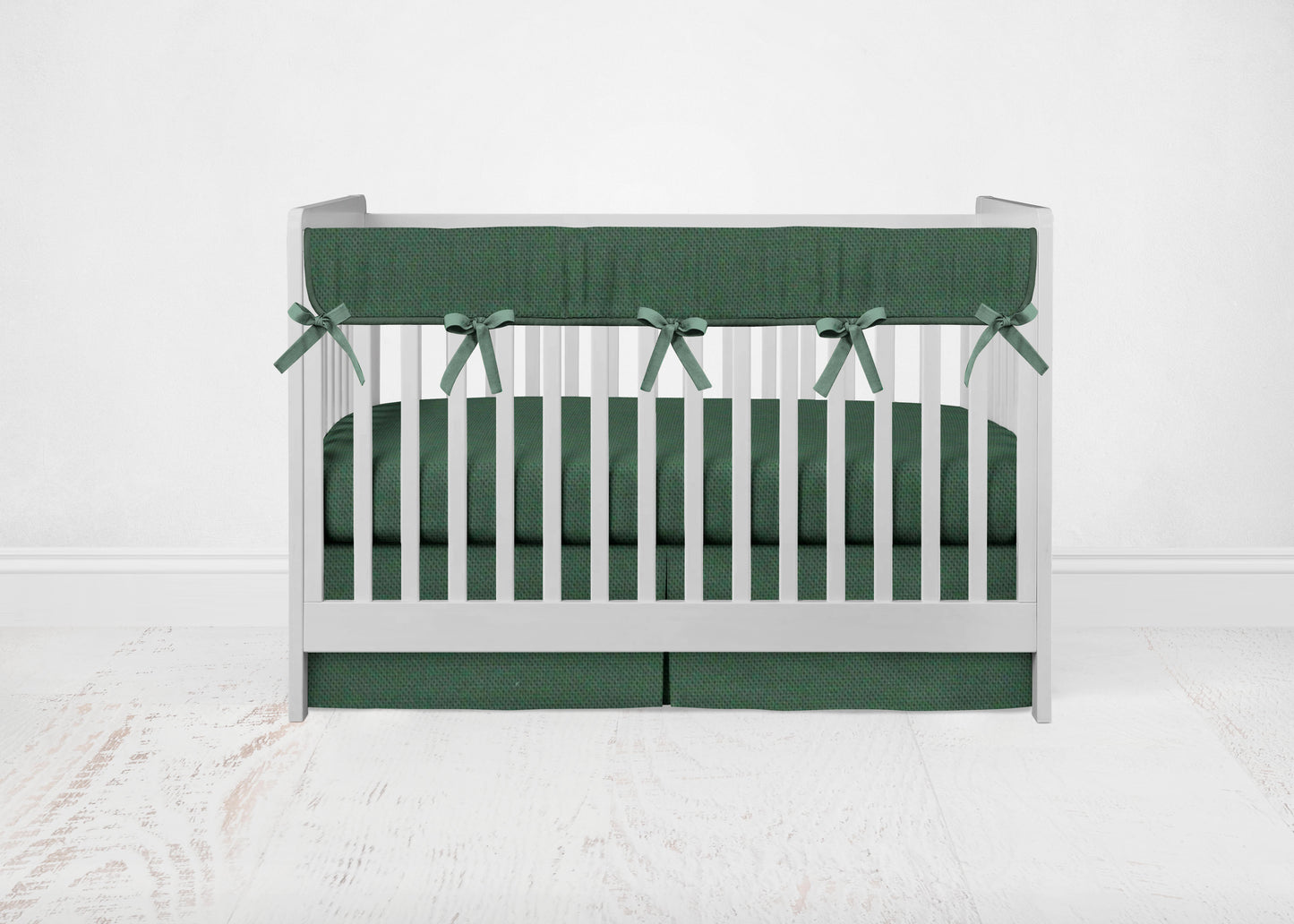 dark hunter green mini crib rail cover with black ties, crib sheet & crib skirt shown in pleat option