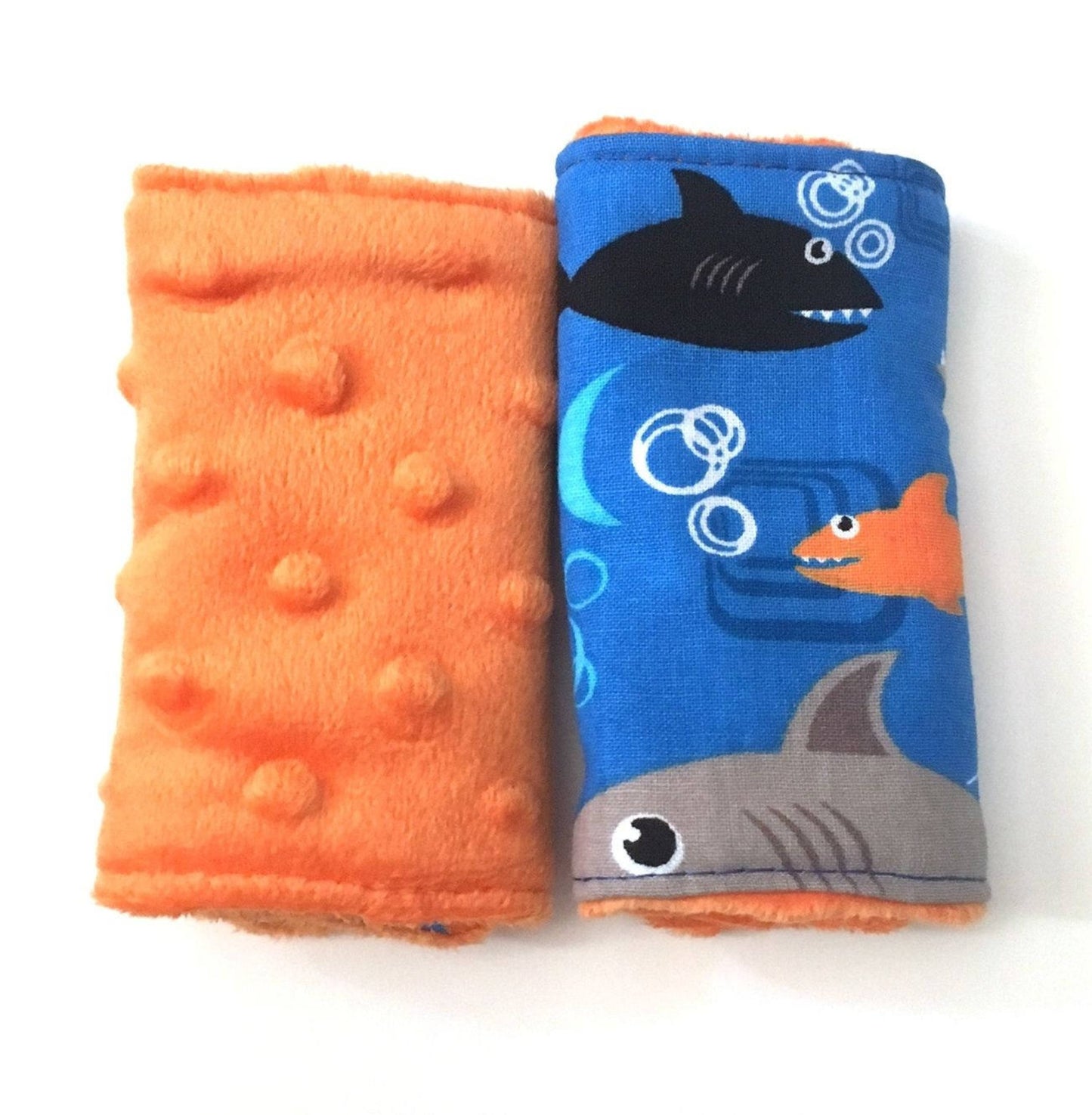 shark car seat strap covers shown with orange minky and 4" size
