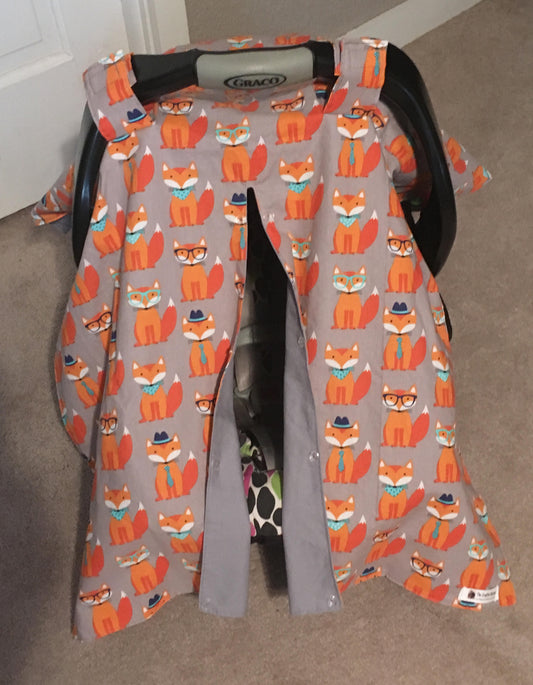 NERDY ORANGE FOX CAR SEAT CANOPY SHOWN WITH GRAY COTTON ON THE BACK AND OPENING ON THE FRONT