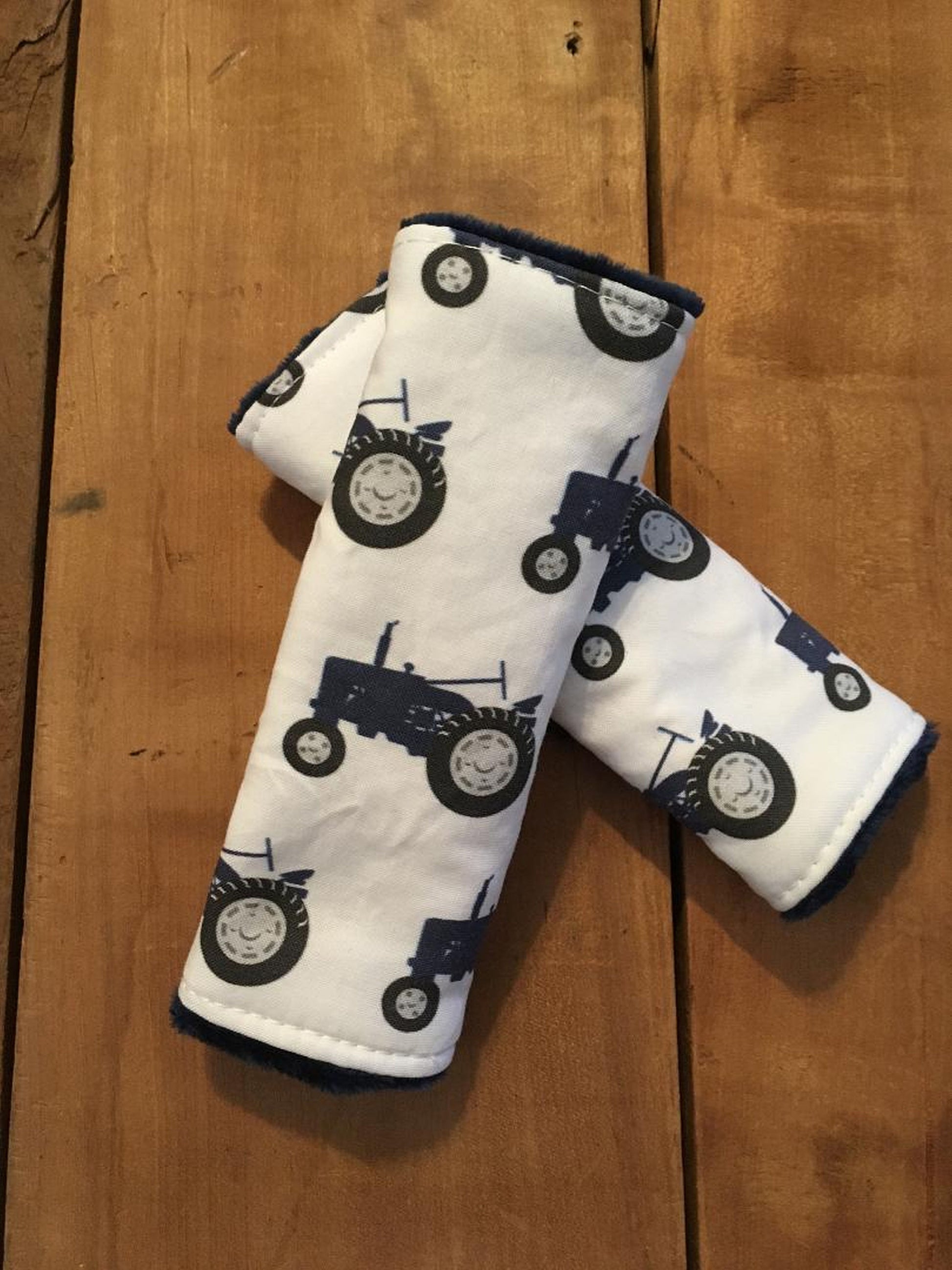 navy tractor car seat strap covers, shown in size 5-6"