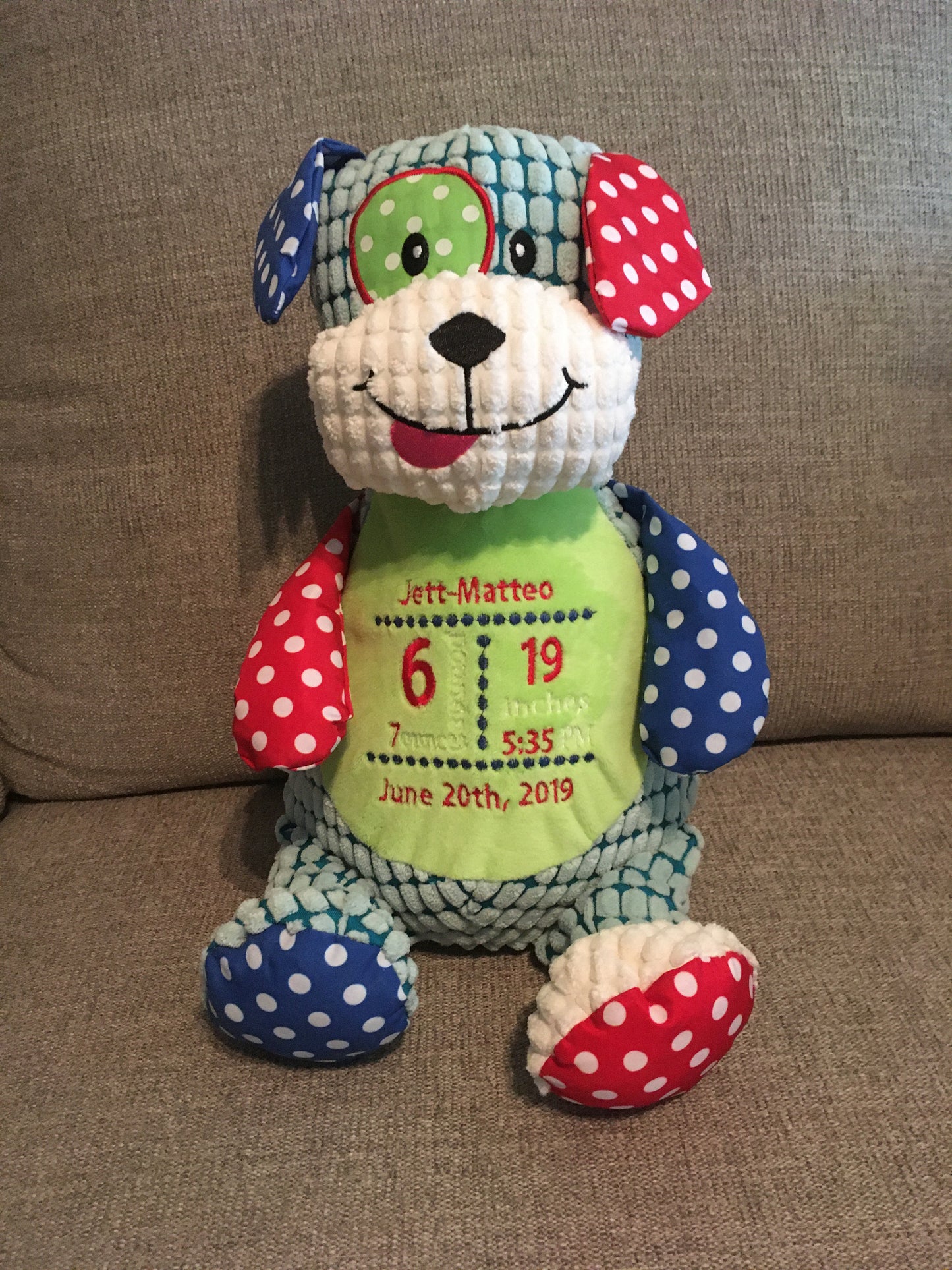 Example showing a dog with the birth state embroidered on the stuffed toy dog's stomach. 